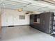 Well-organized garage featuring epoxy flooring, a door to the house, and storage cabinets at 114 Mint Ave # A, Mooresville, NC 28117