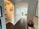 Hallway featuring an archway into rooms, dark wood floors, and art-lined walls at 114 Mint Ave # A, Mooresville, NC 28117