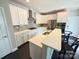 Bright kitchen with white cabinets, stainless steel appliances, and a center island with bar seating at 114 Mint Ave # A, Mooresville, NC 28117