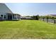 Well-maintained, expansive backyard featuring lush green grass and fencing, ideal for outdoor activities and privacy at 1228 Tranquil Falls Ln, Matthews, NC 28104