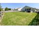 Large backyard with healthy green grass and a fence, providing ample space for recreation and entertainment at 1228 Tranquil Falls Ln, Matthews, NC 28104