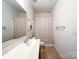 Bathroom with single sink, a mirror, toilet, and a shower with a curtain at 1228 Tranquil Falls Ln, Matthews, NC 28104