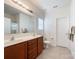 Well-lit bathroom with double sinks, and modern fixtures at 1228 Tranquil Falls Ln, Matthews, NC 28104