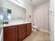 Bathroom featuring double sinks, a large mirror, a toilet, and a shower with a curtain at 1228 Tranquil Falls Ln, Matthews, NC 28104