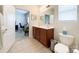 Bright bathroom with double sinks, tile flooring, and modern lighting at 1228 Tranquil Falls Ln, Matthews, NC 28104