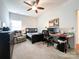 Bedroom with a ceiling fan, carpet, desk, and reading chair at 1228 Tranquil Falls Ln, Matthews, NC 28104
