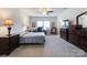 Spacious bedroom with a ceiling fan, comfortable bed, and ample natural light at 1228 Tranquil Falls Ln, Matthews, NC 28104