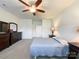 Bright bedroom featuring a ceiling fan, comfortable bed, and plenty of space at 1228 Tranquil Falls Ln, Matthews, NC 28104