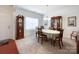 Classic dining room featuring a wooden table set for four, with a grandfather clock and traditional decor at 1228 Tranquil Falls Ln, Matthews, NC 28104