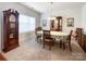Traditional dining room with a wooden table, cabinet, and grandfather clock, creating an inviting atmosphere at 1228 Tranquil Falls Ln, Matthews, NC 28104