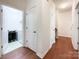 Hallway with hardwood floors leading to a laundry room with a washer and dryer at 1228 Tranquil Falls Ln, Matthews, NC 28104