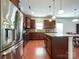 Well-equipped kitchen with stainless steel appliances, a granite island, and dark wood cabinets at 1228 Tranquil Falls Ln, Matthews, NC 28104
