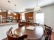 Inviting eat-in kitchen featuring wood cabinets, stainless appliances, and a cozy dining area at 1228 Tranquil Falls Ln, Matthews, NC 28104