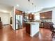 Modern kitchen featuring stainless steel appliances, granite countertops, and rich wood cabinetry at 1228 Tranquil Falls Ln, Matthews, NC 28104