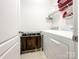 Laundry room featuring a washer, dryer, laundry racks, and storage shelves at 1228 Tranquil Falls Ln, Matthews, NC 28104