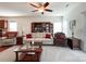 Comfortable living room featuring plush seating, a ceiling fan, and elegant decor at 1228 Tranquil Falls Ln, Matthews, NC 28104