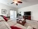 Cozy living room with a ceiling fan, comfortable seating, and access to the patio at 1228 Tranquil Falls Ln, Matthews, NC 28104