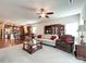 Inviting living room with an open layout to the kitchen, complete with a ceiling fan at 1228 Tranquil Falls Ln, Matthews, NC 28104