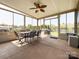 Bright sunroom features a dining set, ample light, and views of the backyard at 1228 Tranquil Falls Ln, Matthews, NC 28104