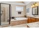 Beautiful bathroom showcasing a soaking tub, shower, and vanity with natural light at 1302 Warrington Pl, Rock Hill, SC 29732