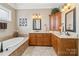 Bathroom featuring a soaking tub, double vanities, and tiled floor at 1302 Warrington Pl, Rock Hill, SC 29732