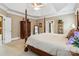 Bedroom featuring four-poster bed and tray ceilings at 1302 Warrington Pl, Rock Hill, SC 29732