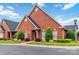 Attractive brick home featuring lush landscaping and a well-maintained lawn at 1302 Warrington Pl, Rock Hill, SC 29732