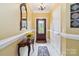 Bright foyer features tile flooring, elegant console table, mirror and stylish lighting at 1302 Warrington Pl, Rock Hill, SC 29732