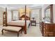 Main bedroom featuring tray ceiling, wood furnishings, and natural lighting at 1302 Warrington Pl, Rock Hill, SC 29732