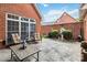 Brick patio features detailed stone flooring, black metal tables, and chairs surrounding a fountain at 1302 Warrington Pl, Rock Hill, SC 29732