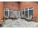 Outdoor patio featuring brick walls, stone floors, chairs, couch and white trim windows for natural light at 1302 Warrington Pl, Rock Hill, SC 29732