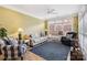Bright sunroom featuring large windows, comfortable seating, and a ceiling fan at 1302 Warrington Pl, Rock Hill, SC 29732