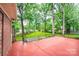 Backyard patio and basketball court, surrounded by mature trees and green grass at 1304 5Th Street Nw Cir, Hickory, NC 28601