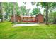 Expansive backyard with a basketball court, screened-in porch, and lush green grass at 1304 5Th Street Nw Cir, Hickory, NC 28601