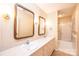 Bathroom showcasing dual sinks, wallpaper, and vanity lighting at 1304 5Th Street Nw Cir, Hickory, NC 28601