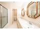 Bathroom with dual sinks, large mirrors, and shower with glass door at 1304 5Th Street Nw Cir, Hickory, NC 28601