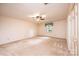 Spacious bedroom features neutral carpet, ceiling fan, and natural lighting at 1304 5Th Street Nw Cir, Hickory, NC 28601