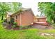 Exterior view of home, showing brick facade, patio, and surrounding landscaping at 1304 5Th Street Nw Cir, Hickory, NC 28601