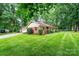 Well-maintained home with a brick facade, attached garage, and green lawn at 1304 5Th Street Nw Cir, Hickory, NC 28601