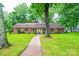 Charming single-story brick home with a well-manicured lawn and inviting walkway at 1304 5Th Street Nw Cir, Hickory, NC 28601
