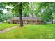Charming brick home with manicured lawn and mature trees, offering classic curb appeal at 1304 5Th Street Nw Cir, Hickory, NC 28601