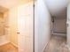 Hallway with doorway to bathroom, and view into carpeted hallway at 1304 5Th Street Nw Cir, Hickory, NC 28601
