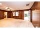 Bright living room with ample windows, wood paneled walls and neutral carpet at 1304 5Th Street Nw Cir, Hickory, NC 28601