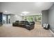 Spacious basement featuring a large seating area with leather reclining chairs and large windows overlooking the backyard at 16229 Loch Raven Rd, Huntersville, NC 28078