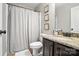 Bathroom featuring a dark vanity with a granite countertop, a white toilet, and a white shower curtain at 16229 Loch Raven Rd, Huntersville, NC 28078