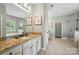 Well-lit bathroom with granite countertops, double sinks, and a separate shower and tub at 16229 Loch Raven Rd, Huntersville, NC 28078