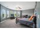 Spacious bedroom featuring neutral paint, carpet, and multiple windows for ample natural light at 16229 Loch Raven Rd, Huntersville, NC 28078