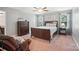 Comfortable bedroom with a wood-framed bed, matching furniture, and light gray walls at 16229 Loch Raven Rd, Huntersville, NC 28078