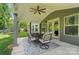 Inviting covered patio featuring an outdoor dining set and ceiling fan, perfect for relaxing and entertaining guests at 16229 Loch Raven Rd, Huntersville, NC 28078