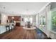 Open concept with bar seating and stainless appliances in the kitchen with a sun-drenched dining area at 16229 Loch Raven Rd, Huntersville, NC 28078